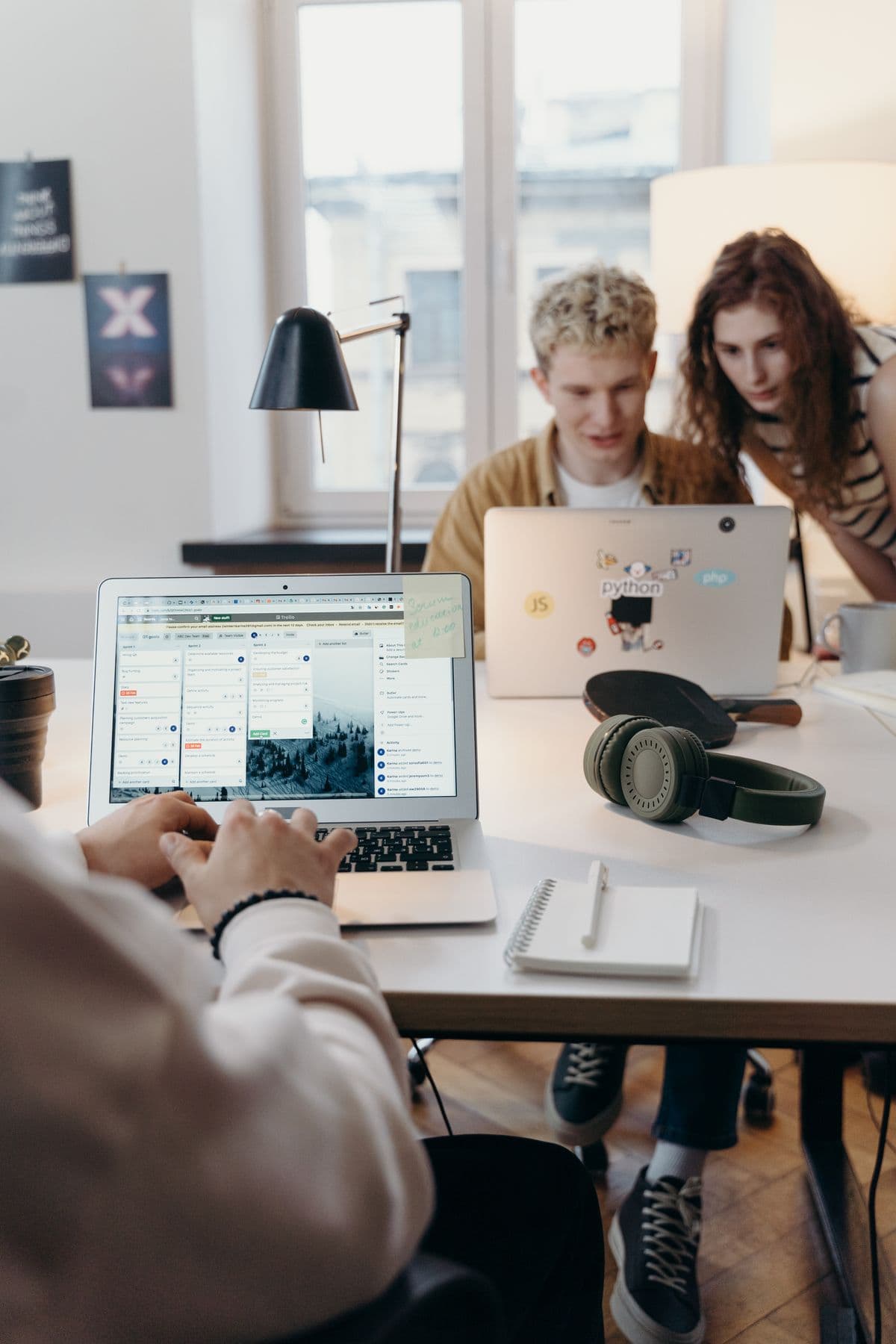 Two young developers looking at a laptop together